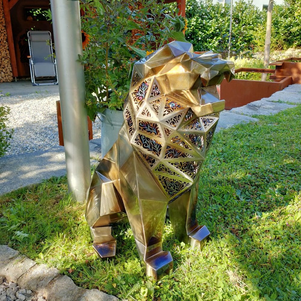 Golden baby lion sculpture featuring polygonal structure and ornate laser-cut patterns